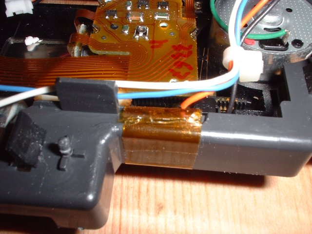 tape holding lateral motor cables to cradle